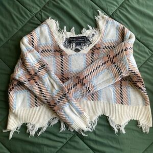 Cream, pink, and blue cropped plaid sweater with frayed hem